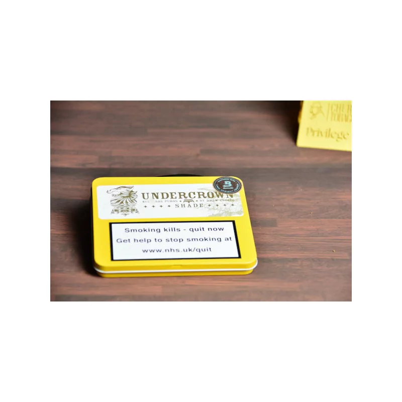 Empty small cigar tin under crown